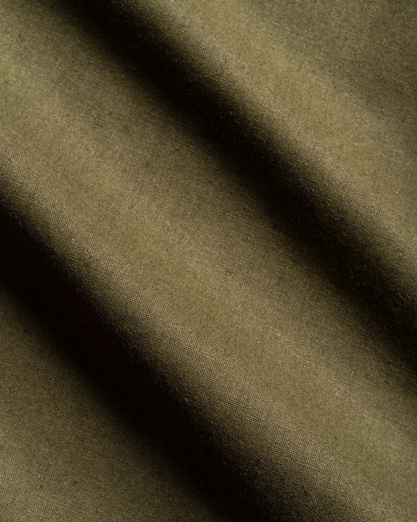Close-up of brown fabric with a diagonal shadow
