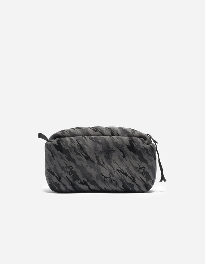A gray neoprene cube storage pouch with a camouflage pattern, featuring a zipper closure and a small loop on one end.