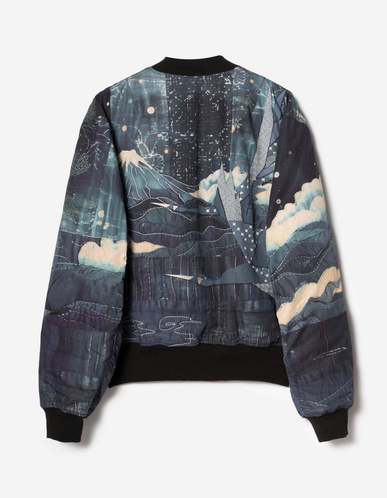 dark blue maharishi embroidered jacket with abstract patterns and light green pants on a white background