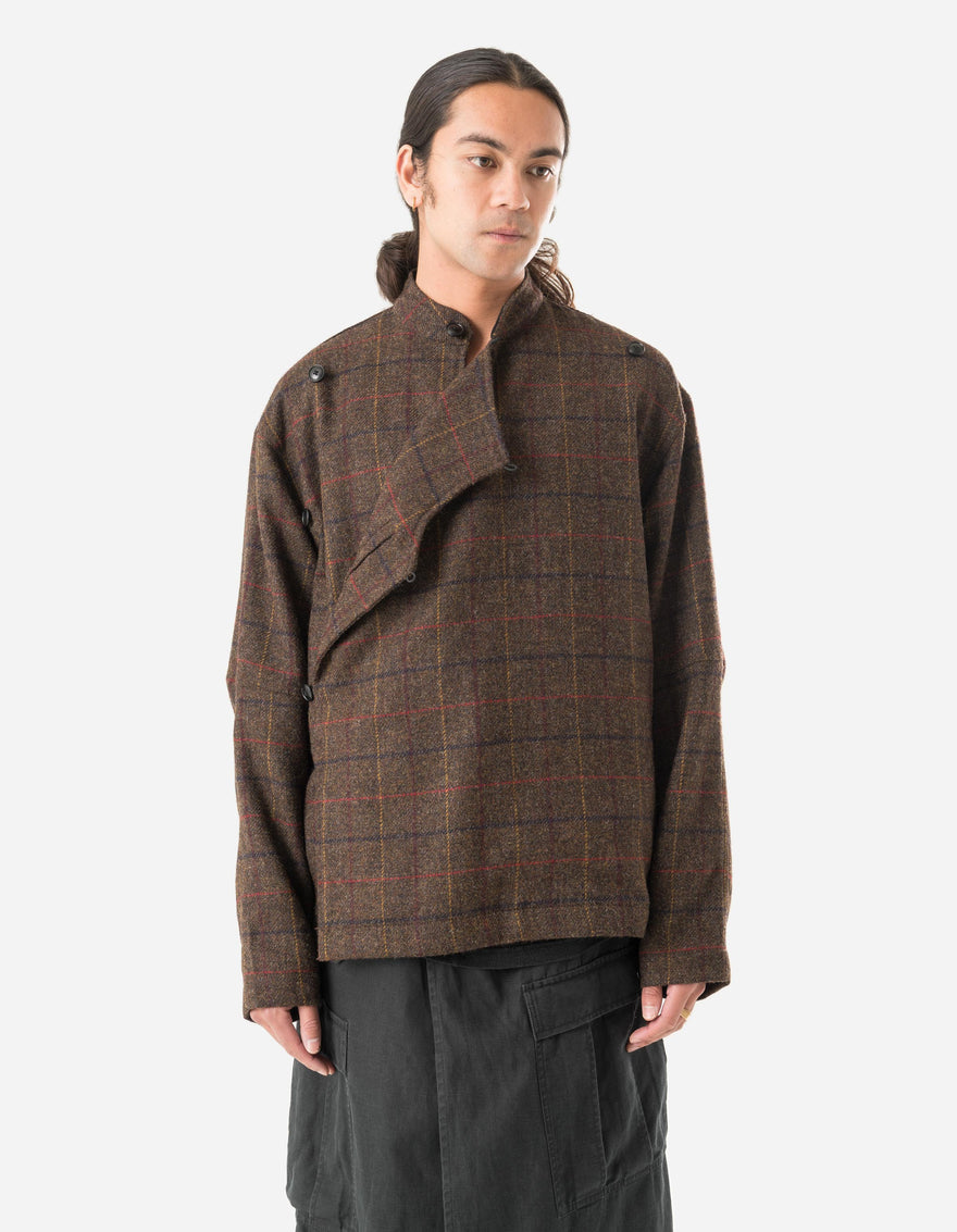 Person wearing a brown plaid jacket on a white background