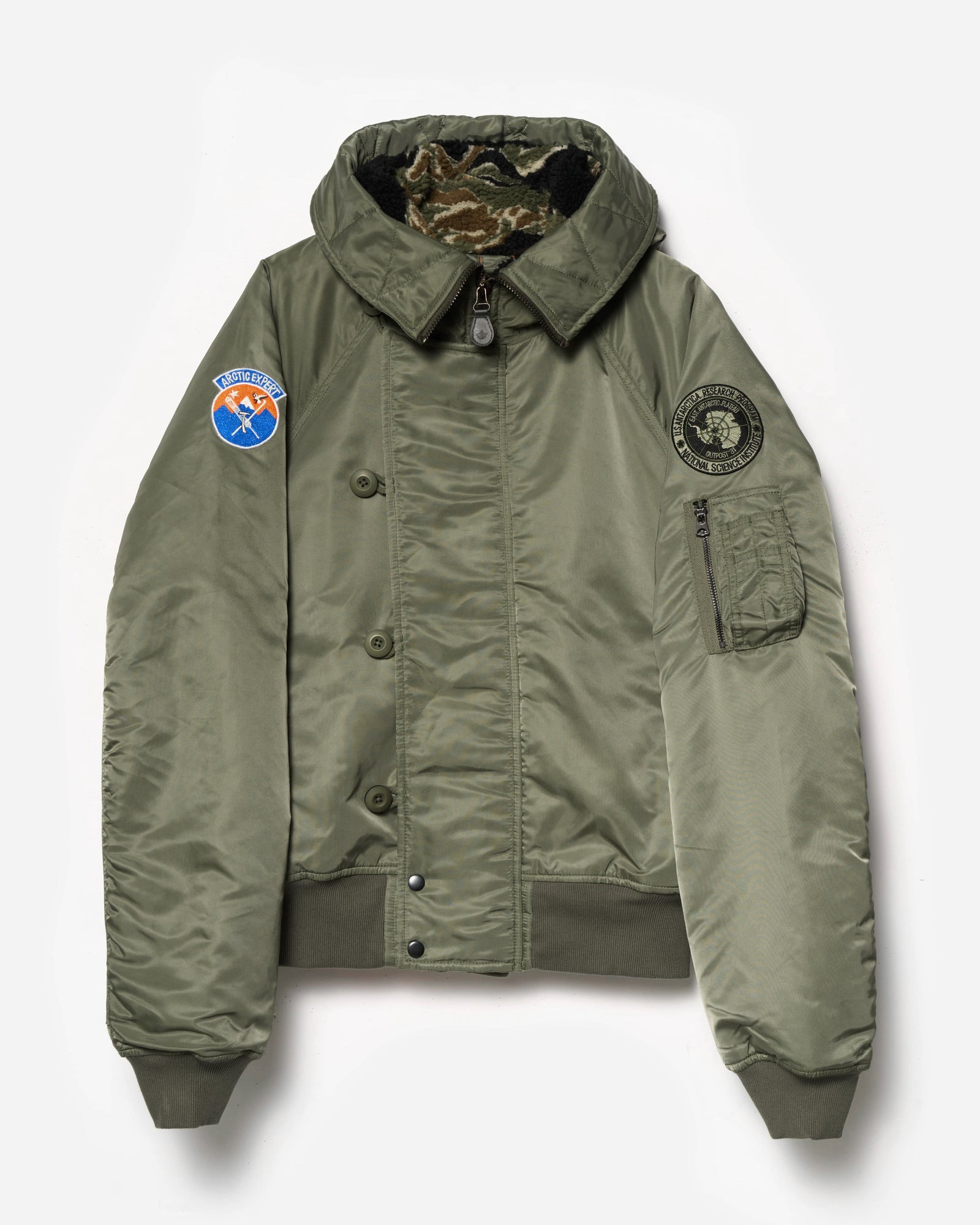 Green jacket with patches on a white background