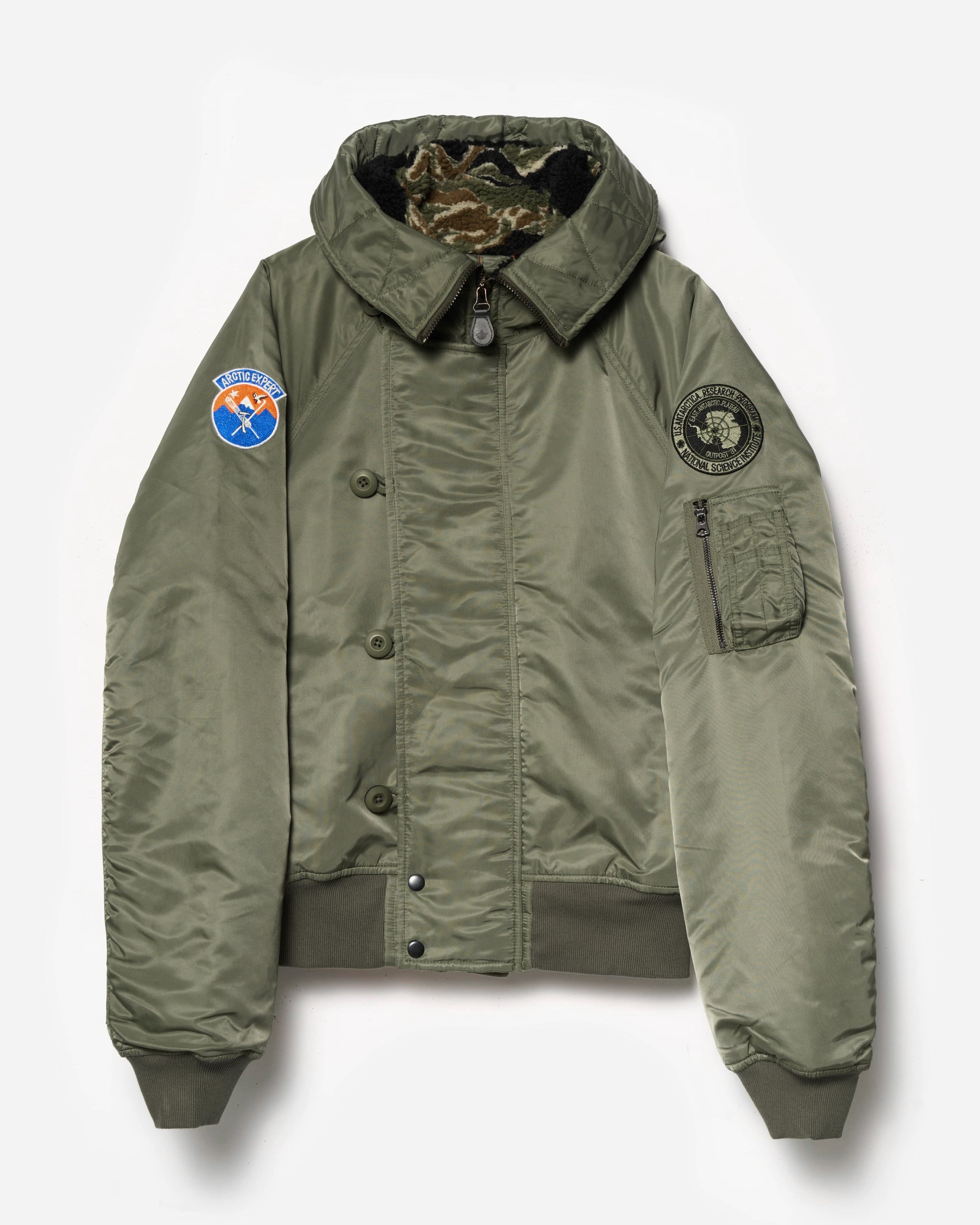 Green jacket with patches on a white background