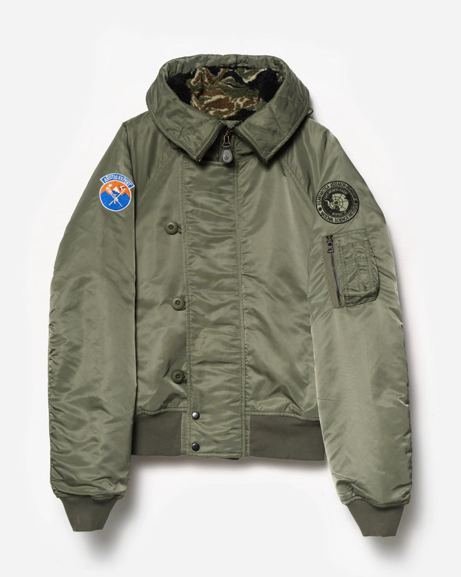 Green jacket with patches on a white background