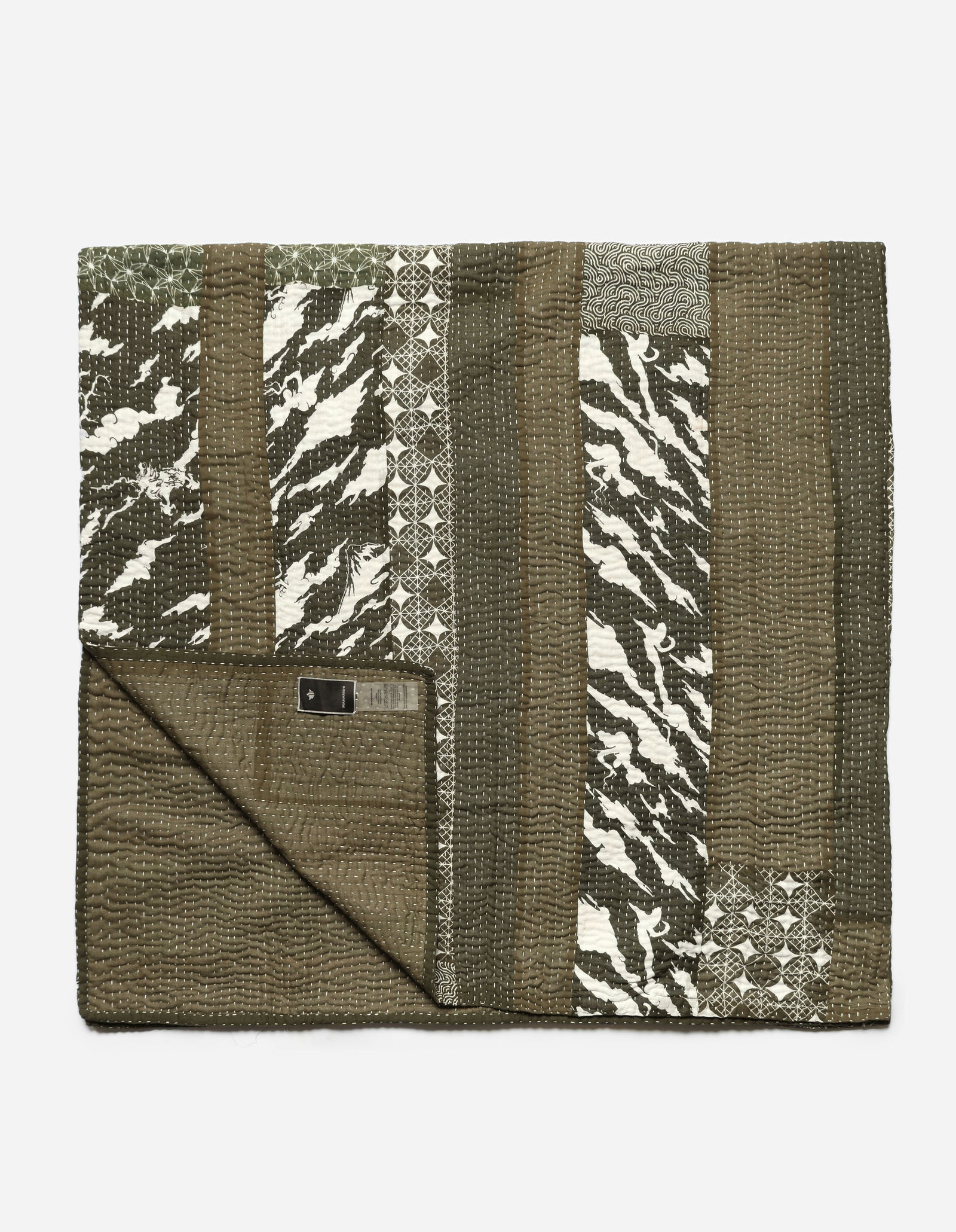 Folded blanket with geometric pattern on a white background