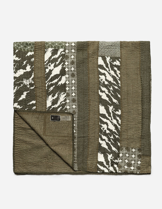 Folded blanket with geometric pattern on a white background