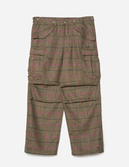 Loose fit cargo pants with a wool check pattern in olive and red colors, featuring two cargo leg pockets, a cinchable belt loop waist, and articulated knee shape.