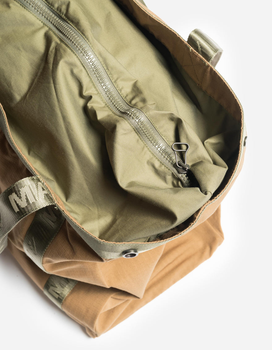 Brown and green bag with a zipper on a white background