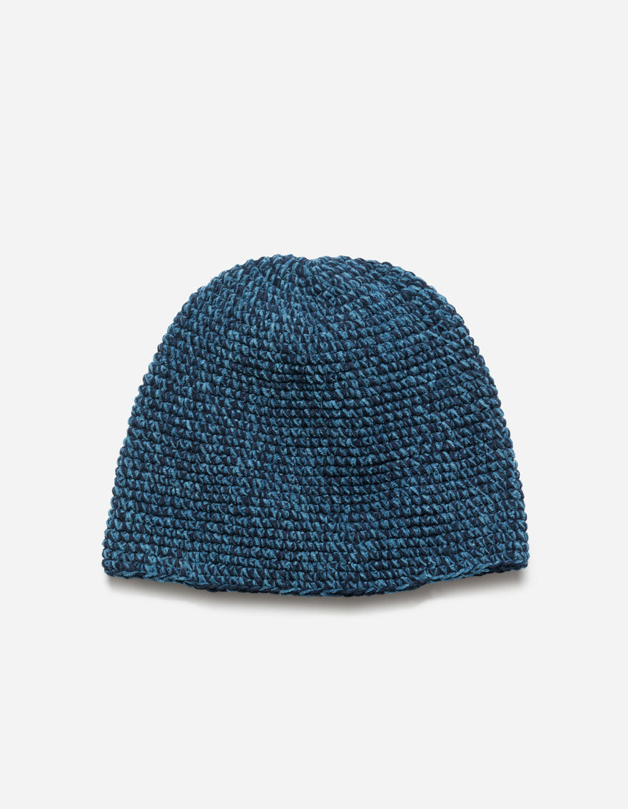 Blue knitted beanie on a light gray background