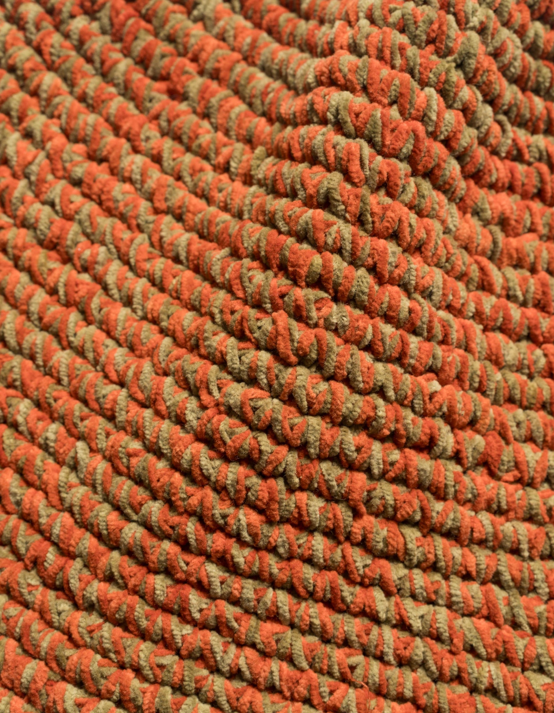 Close-up of a textured orange and green fabric pattern