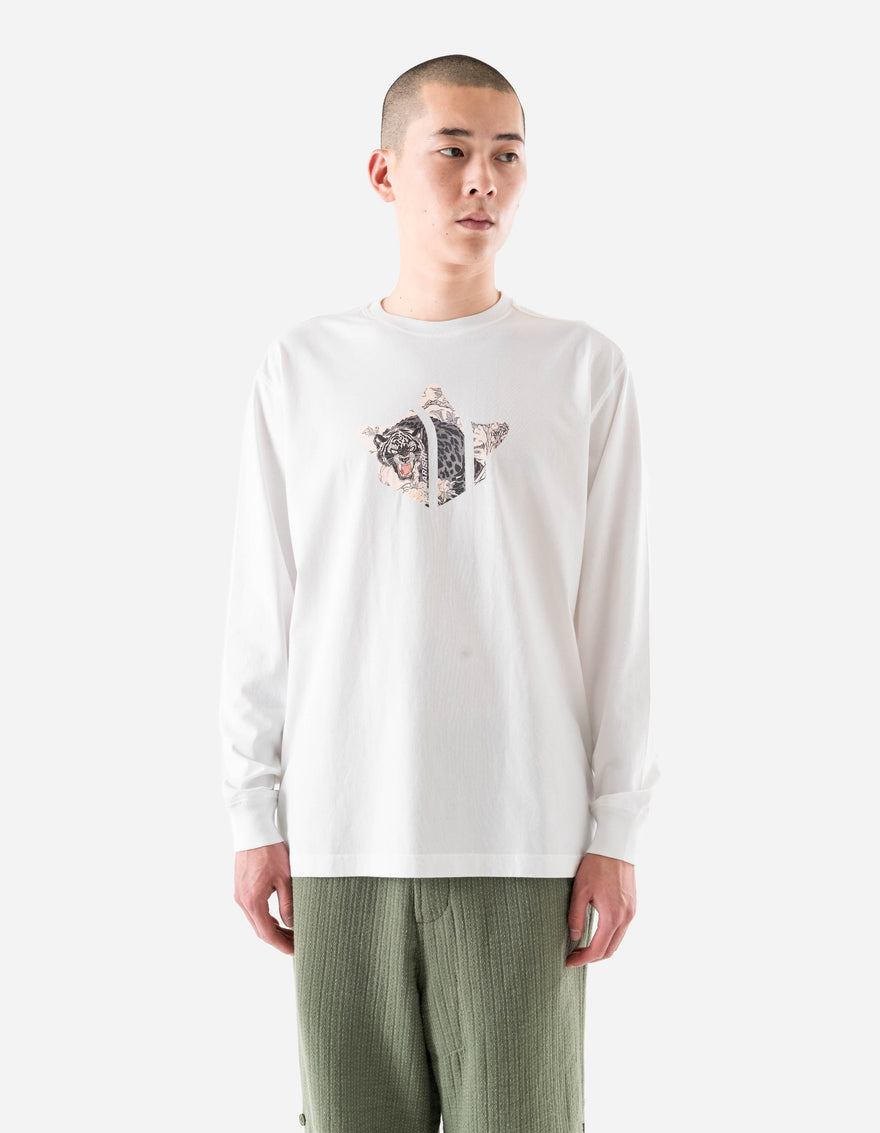 Person wearing a white long-sleeve shirt with a graphic design on a plain background