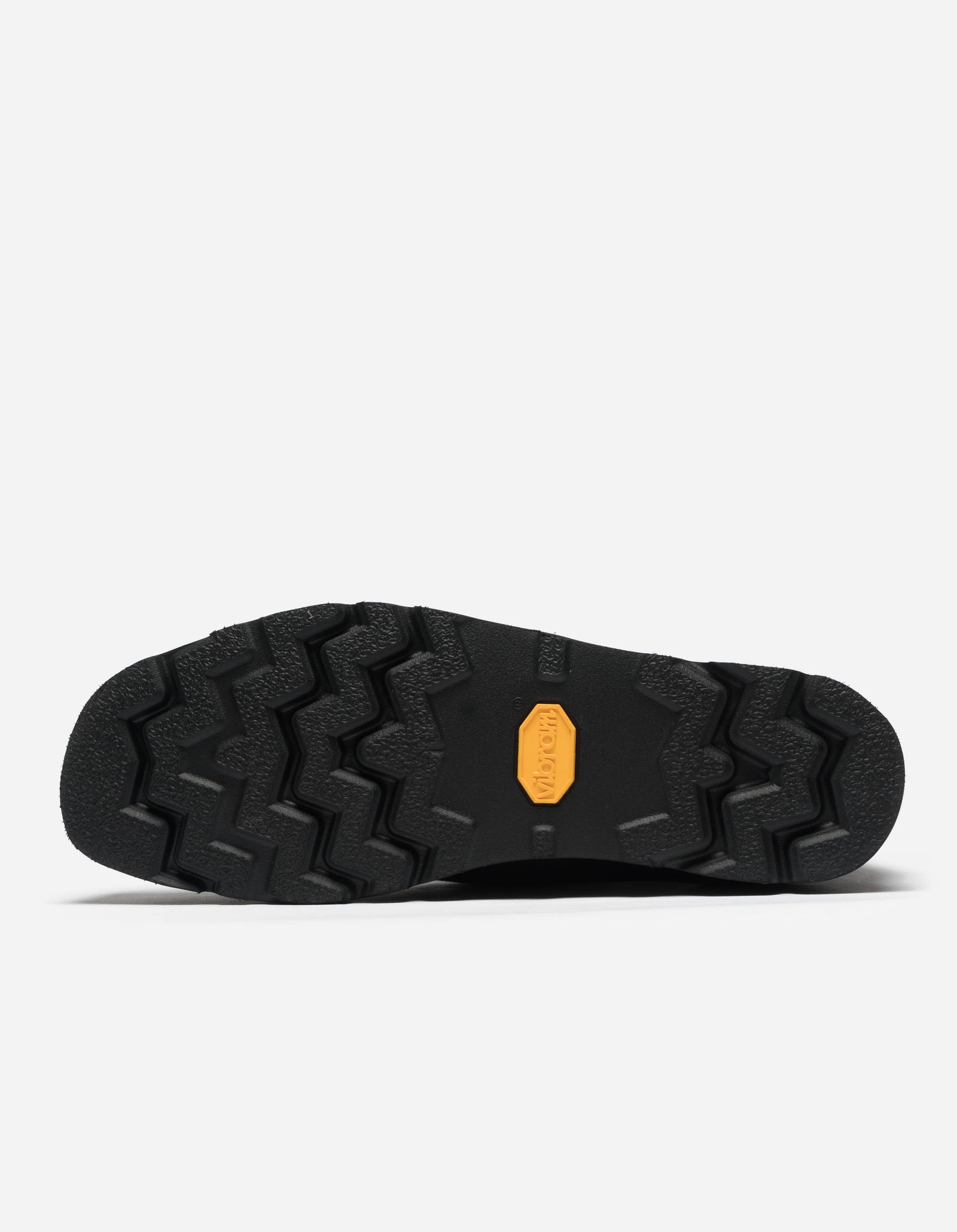 Black shoe sole with orange logo on a white background