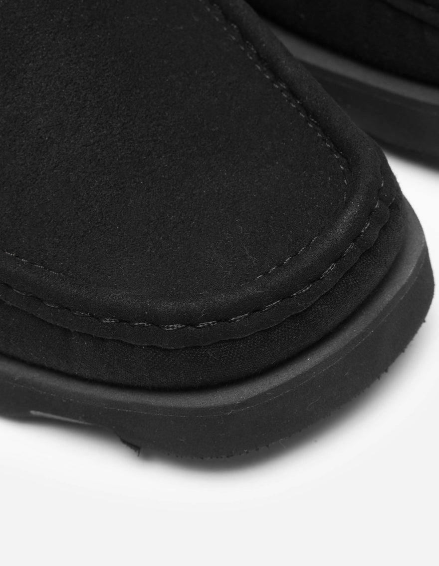 Close-up of a black sandal on a white background