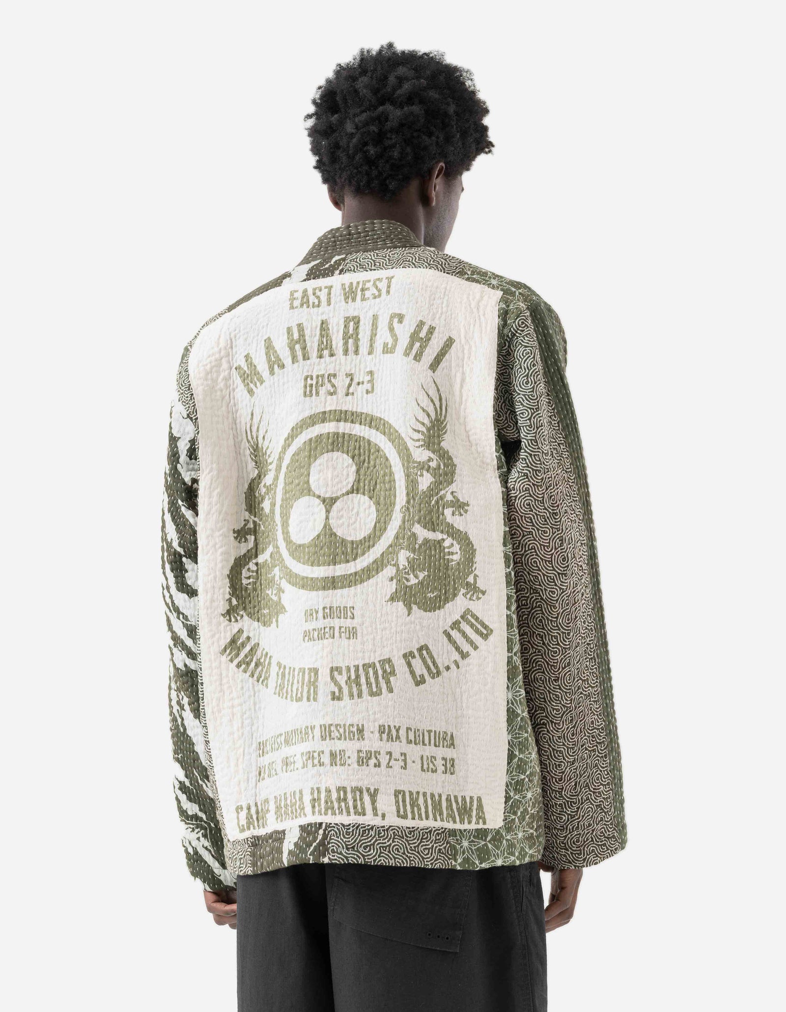 Person wearing a jacket with branding and text on the back