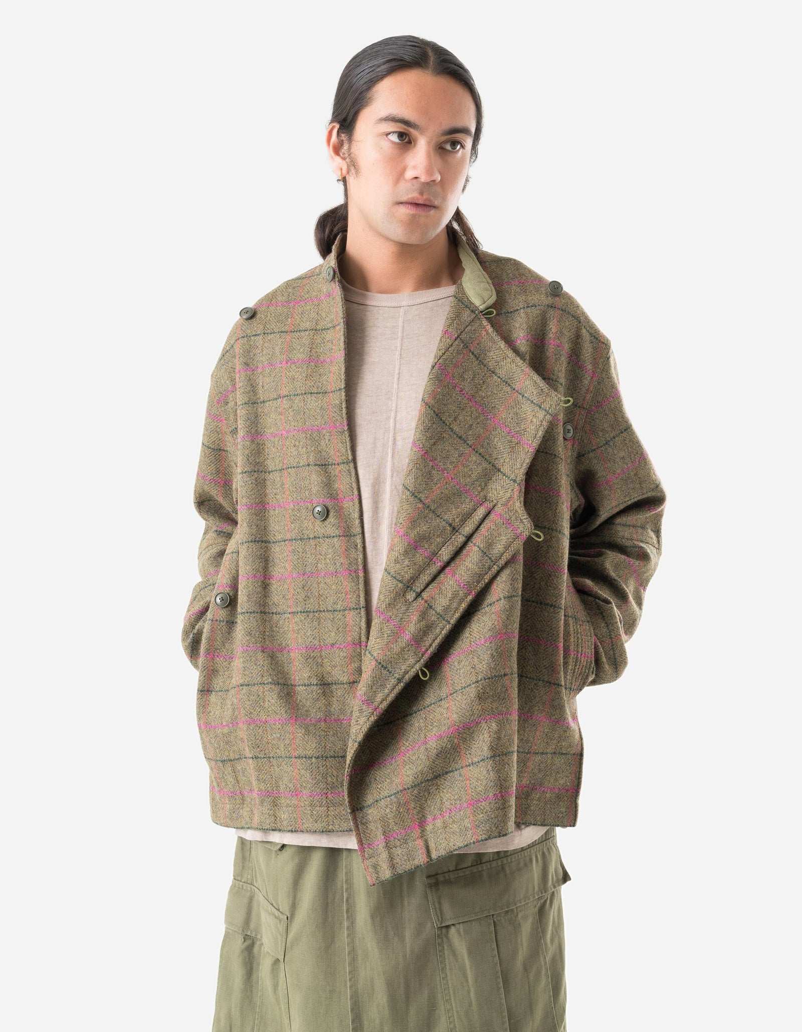 Man wearing a plaid jacket and pants on a white background