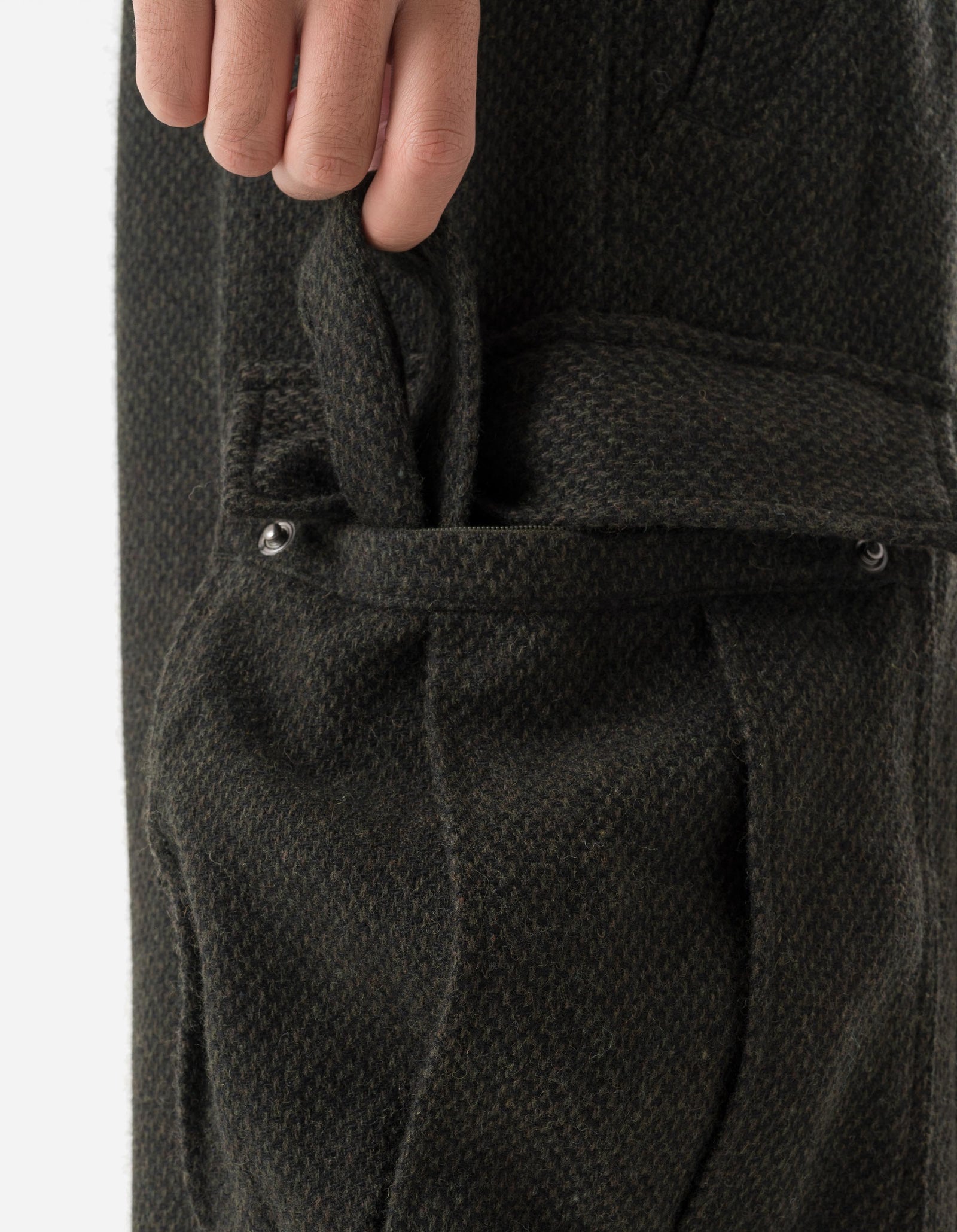 Close-up of a dark gray textured fabric with buttons on a white background