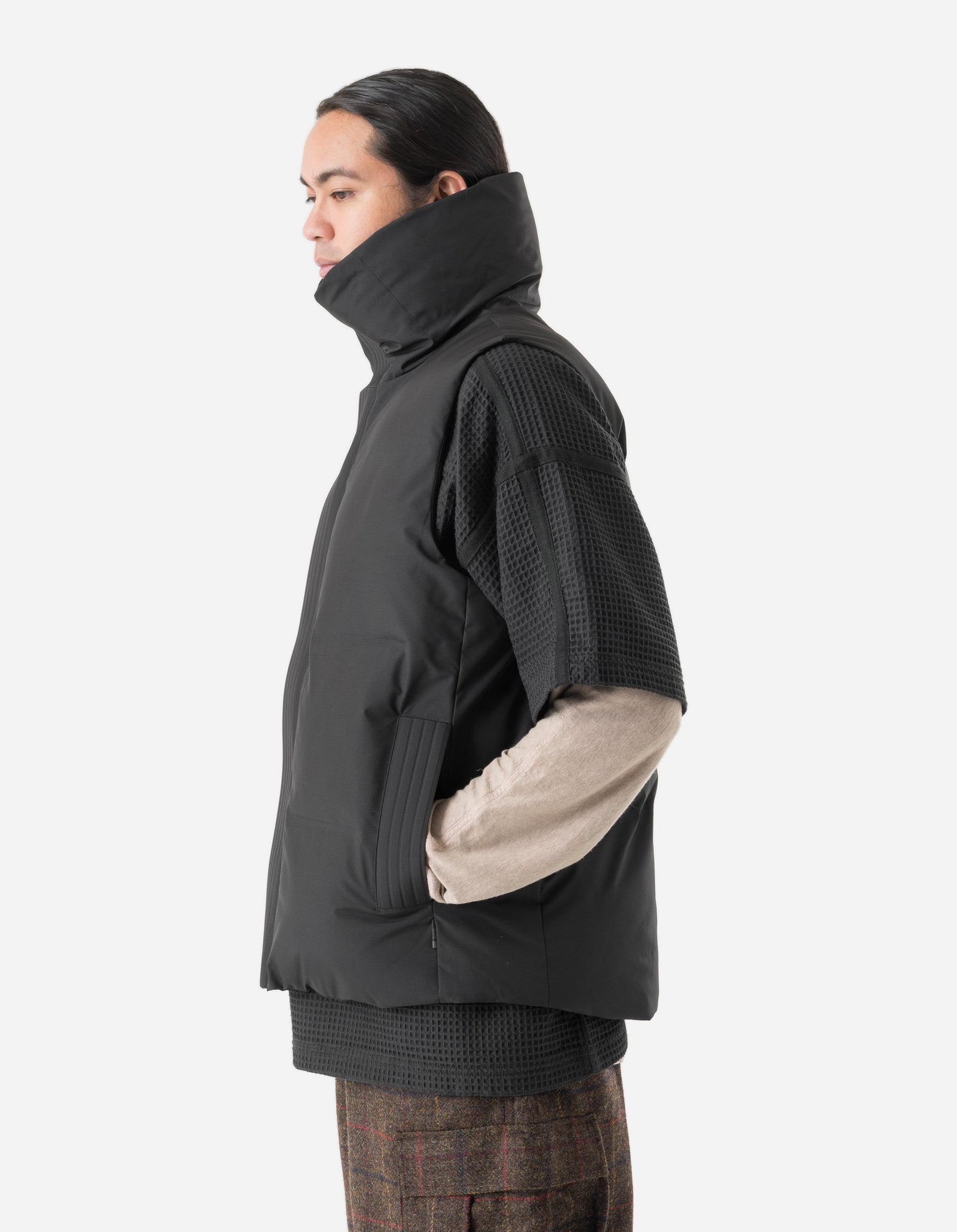 Person wearing a black jacket with a white background