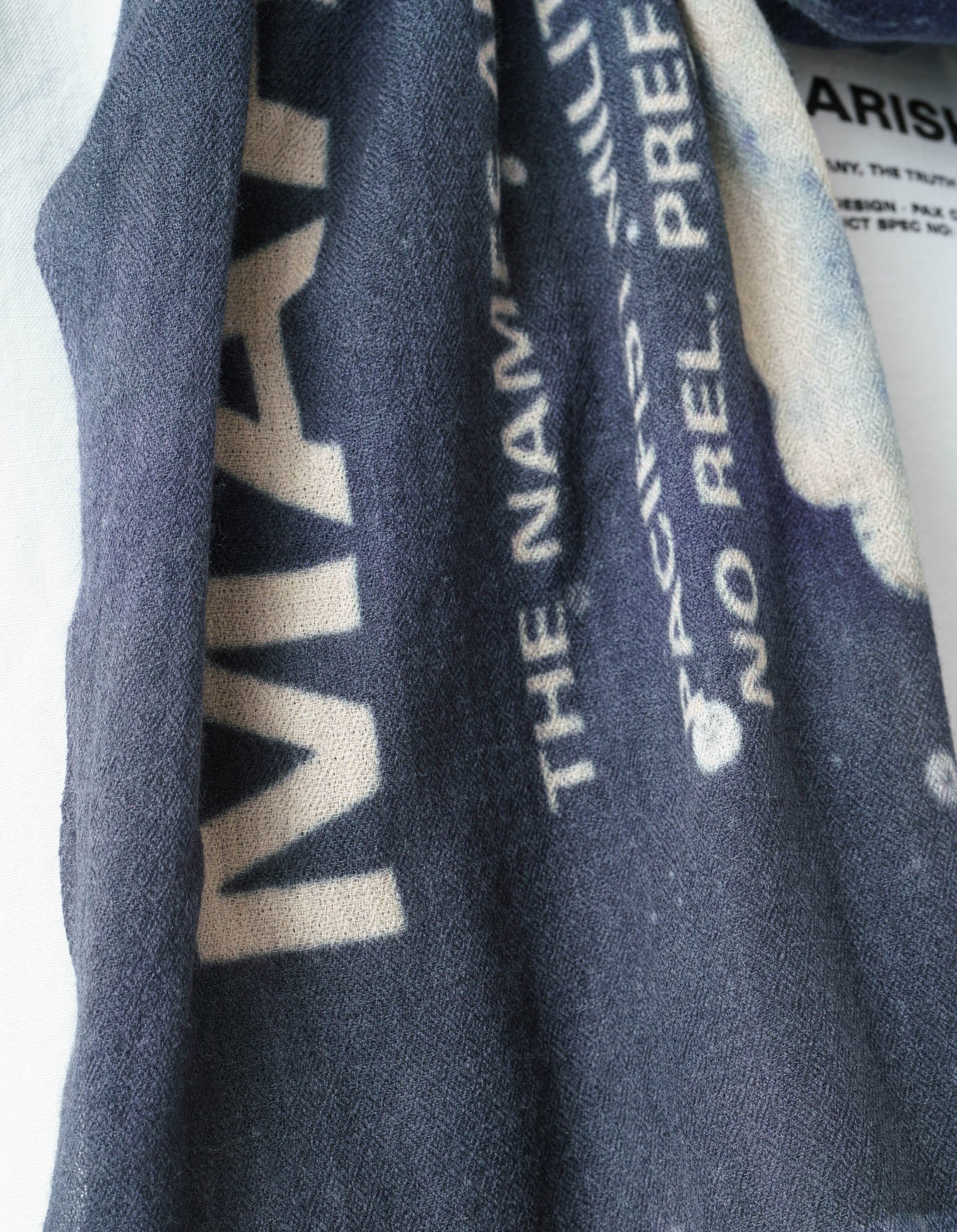 Close-up of a dark blue fabric with text and logos.