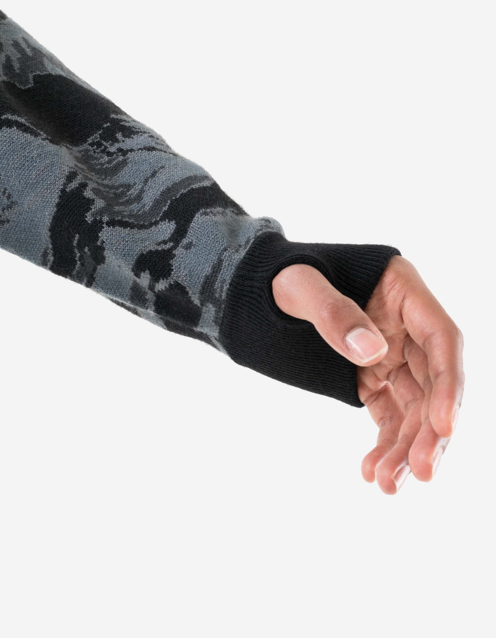 Camouflage-patterned arm sleeve on a person's arm with a white background