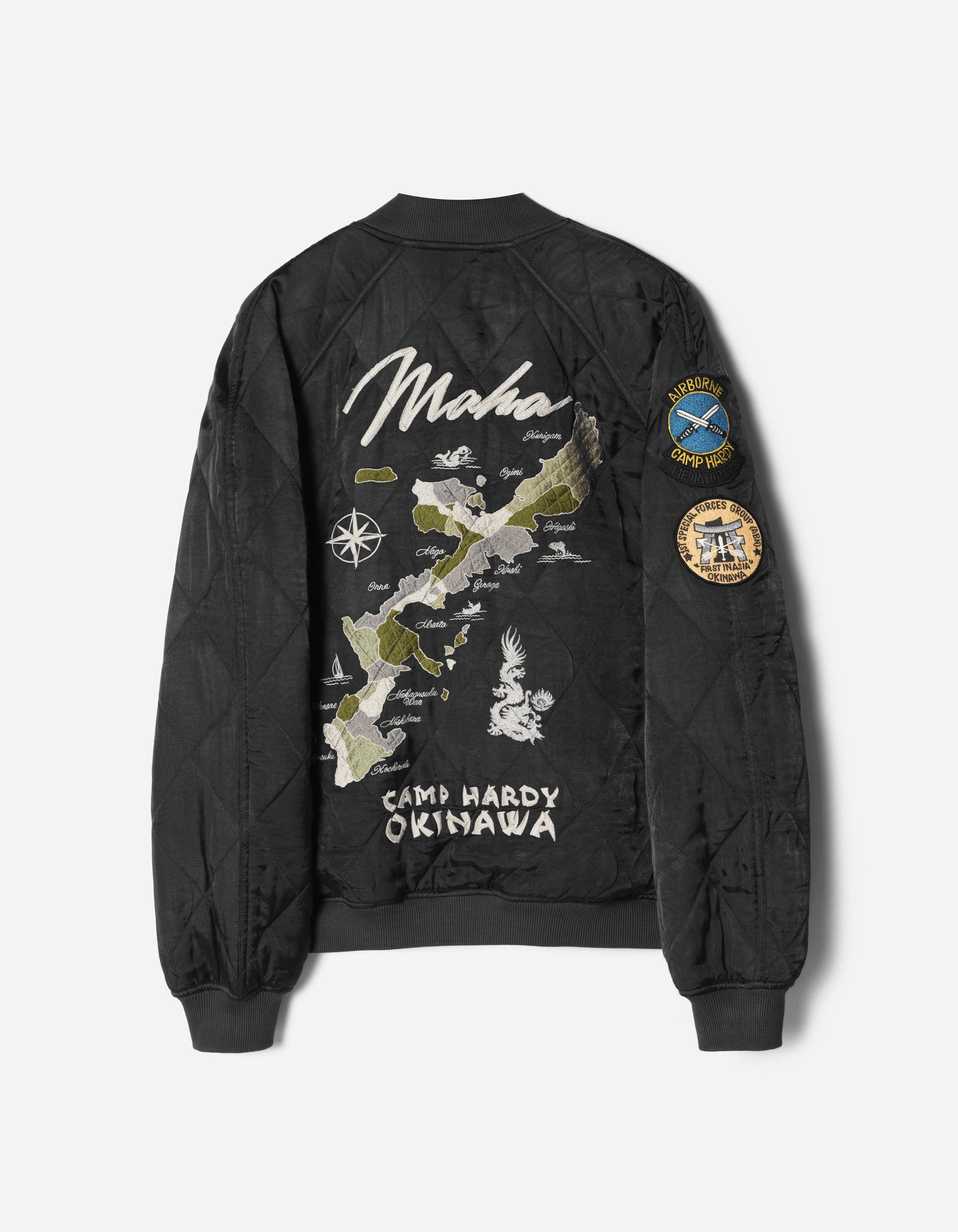 Black bomber jacket with embroidered design and patches on a white background