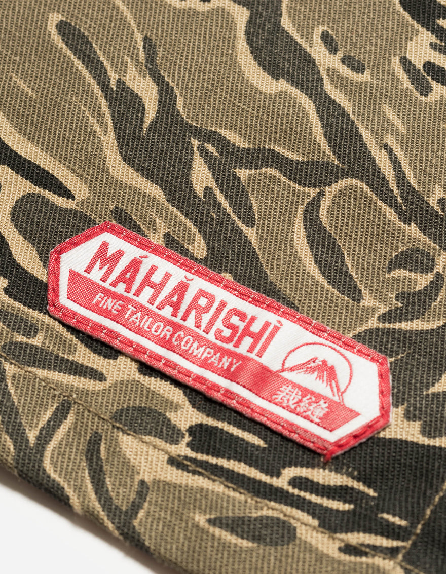 Camouflage fabric with a red and white 'Maharishi' label