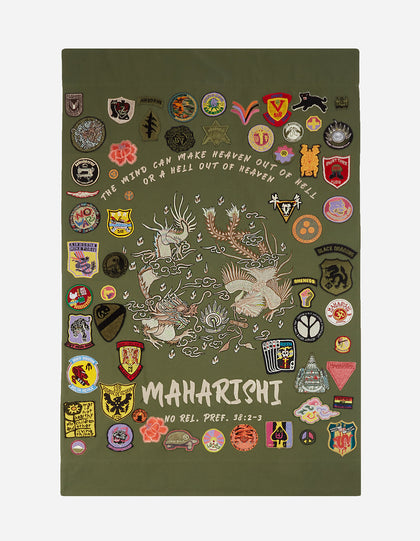 A decorative tapestry with a green background featuring a dragon, along with various colorful badges and patches with different designs and texts.